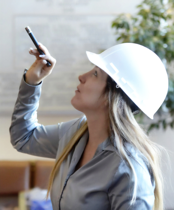 photograph of artist Jezebel during the construction of Illumination Tree, a large scale sculptural chandelier